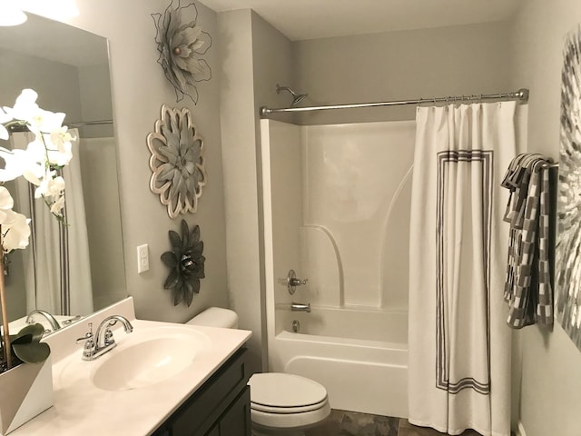 full bath with toilet, shower / bath combo with shower curtain, and vanity