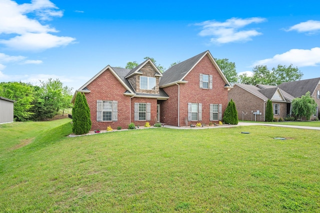 traditional-style house with brick siding and a front yard