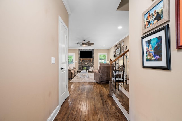 hall with crown molding, dark wood finished floors, recessed lighting, baseboards, and stairway