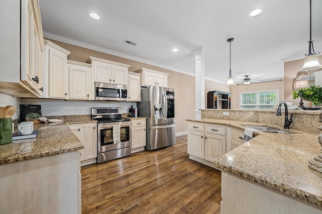 kitchen featuring visible vents, ornamental molding, a ceiling fan, a sink, and stainless steel appliances