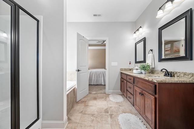 full bathroom with double vanity, visible vents, a shower stall, a sink, and ensuite bath