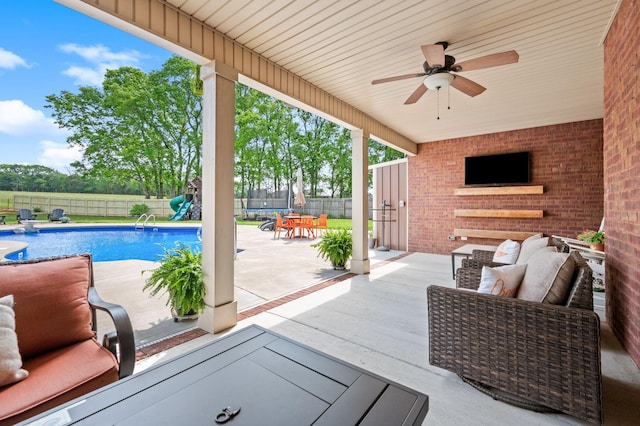 view of patio / terrace featuring a fenced backyard, a ceiling fan, a trampoline, and a fenced in pool
