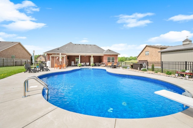 view of pool featuring a fenced in pool, a fenced backyard, a patio area, and a diving board