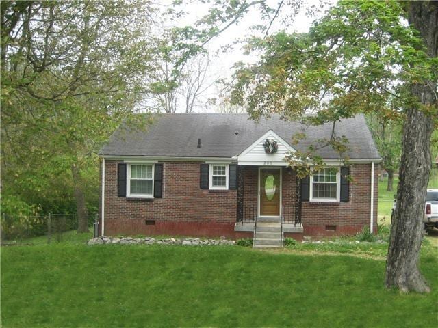 view of front of house featuring a front lawn, crawl space, and brick siding