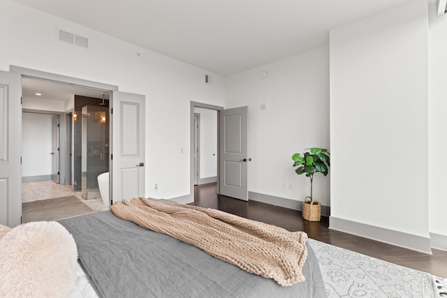 bedroom with visible vents and wood finished floors
