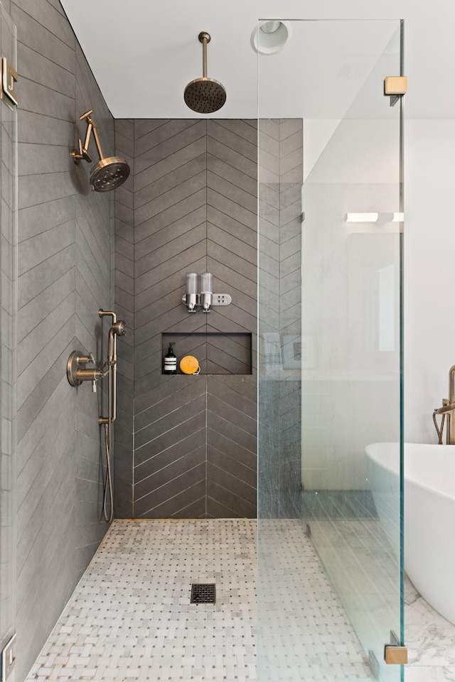 bathroom with a tile shower and a soaking tub