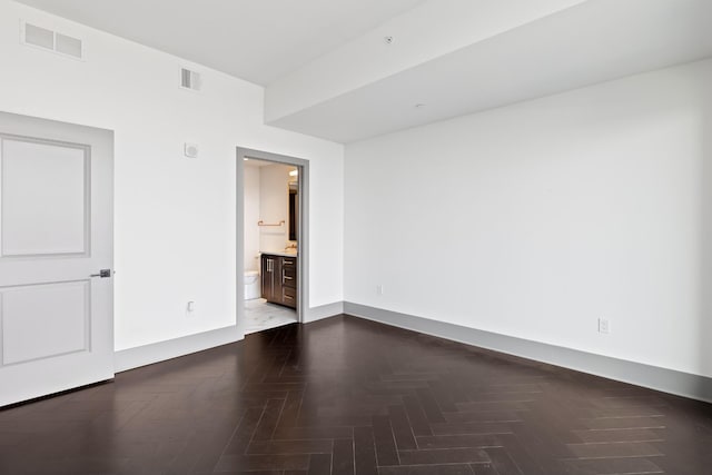 unfurnished room featuring visible vents
