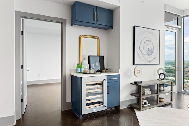 bar with dark wood-style flooring, a dry bar, and wine cooler
