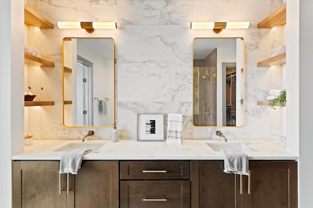 full bathroom featuring an enclosed shower, double vanity, and a sink
