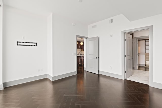 unfurnished bedroom with visible vents and baseboards