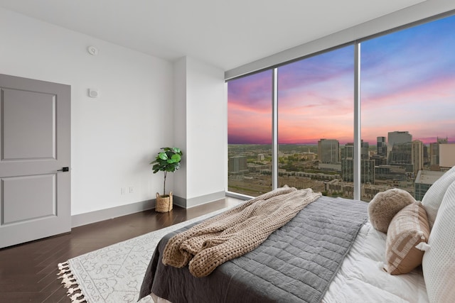 bedroom featuring access to outside, baseboards, and wood finished floors