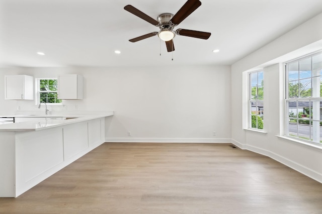 interior space with plenty of natural light, light wood finished floors, recessed lighting, and baseboards