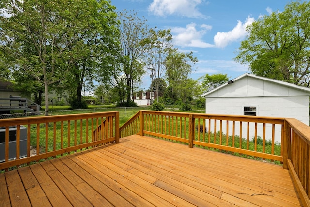 wooden terrace with a yard and a fenced backyard