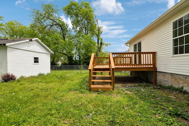 view of yard featuring a wooden deck, stairway, and fence
