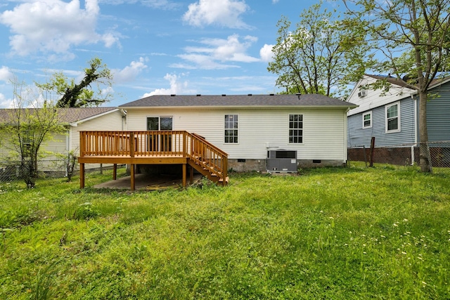 back of property featuring a wooden deck, crawl space, a fenced backyard, cooling unit, and a lawn