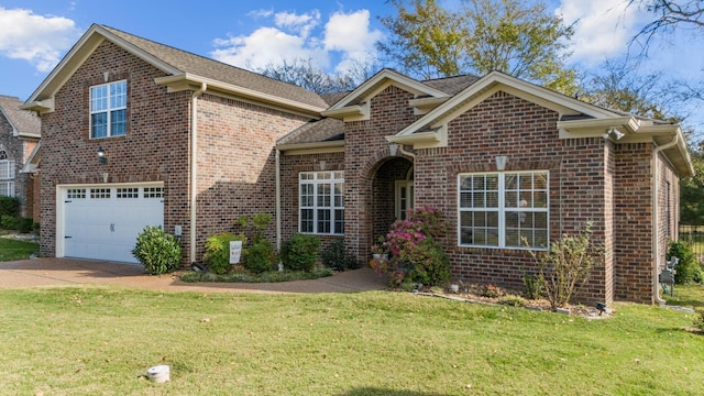 view of front of property with brick siding, a garage, a front lawn, and driveway
