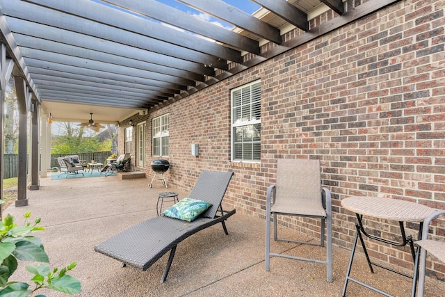 view of patio featuring a ceiling fan and fence
