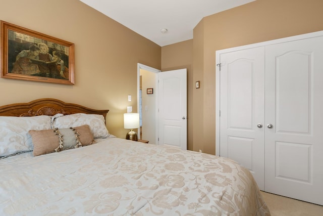 bedroom with a closet and light carpet
