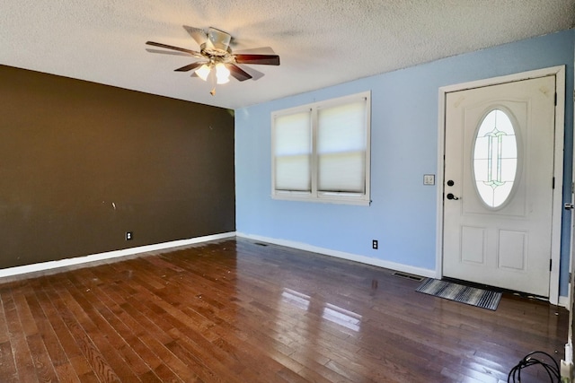 foyer entrance featuring baseboards, wood finished floors, a ceiling fan, and a textured ceiling