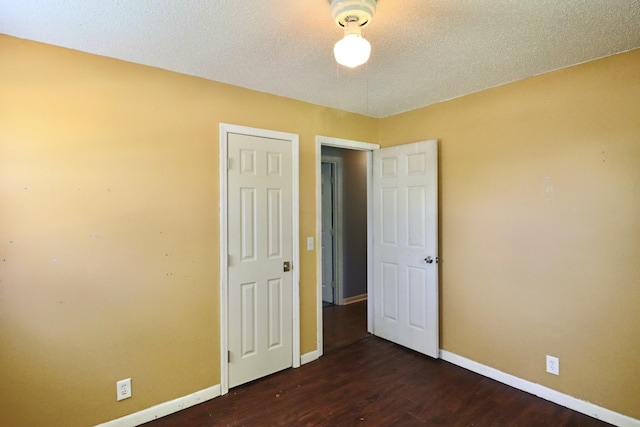 unfurnished bedroom featuring wood finished floors and baseboards