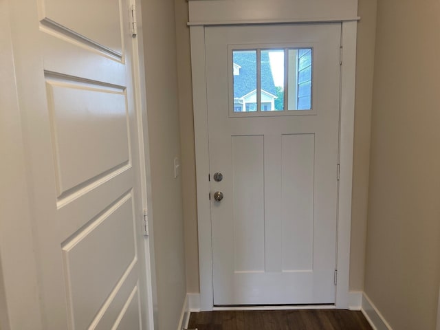 entryway with baseboards and dark wood-type flooring