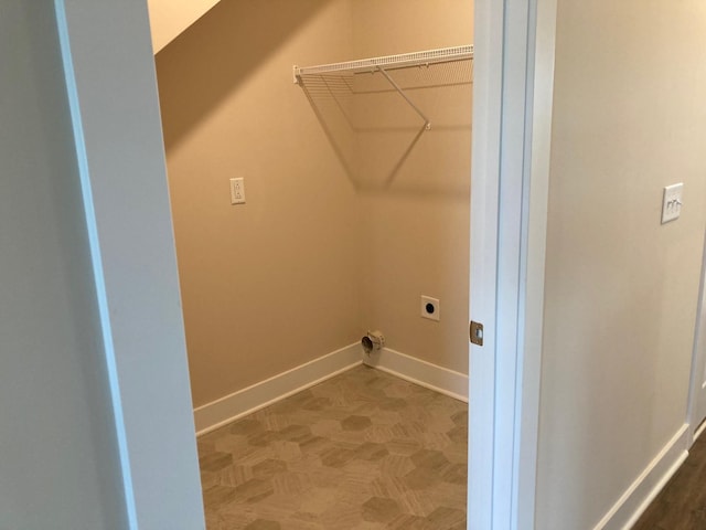 laundry area featuring baseboards, laundry area, and hookup for an electric dryer