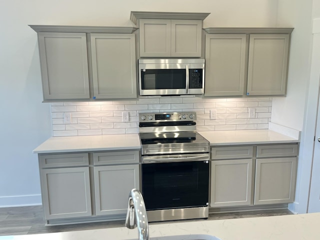 2633 Unitas E, Murfreesboro, TN 37129 - kitchen featuring appliances with stainless steel finishes, gray cabinetry, and backsplash