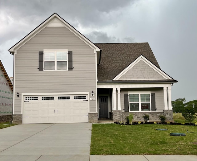 2633 Unitas E, Murfreesboro, TN 37129 - craftsman-style house featuring stone siding, concrete driveway, an attached garage, a front lawn, and roof with shingles