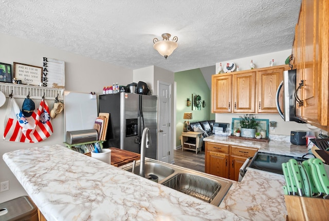 204 Commanche Dr, Hohenwald, TN 38462 - kitchen with a sink, a textured ceiling, appliances with stainless steel finishes, and light countertops