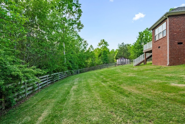 204 Commanche Dr, Hohenwald, TN 38462 - view of yard featuring a fenced backyard, stairs, and a wooden deck