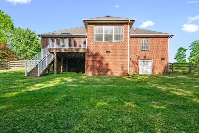 204 Commanche Dr, Hohenwald, TN 38462 - rear view of house with a wooden deck, a fenced backyard, stairs, brick siding, and a yard
