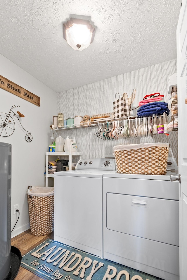 204 Commanche Dr, Hohenwald, TN 38462 - washroom featuring a textured ceiling, laundry area, washer and clothes dryer, and wood finished floors