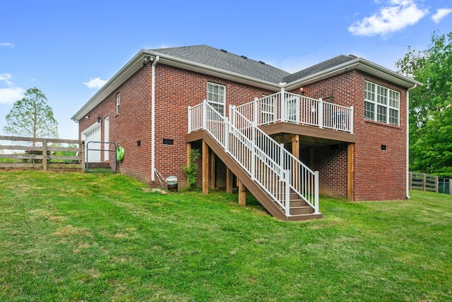 204 Commanche Dr, Hohenwald, TN 38462 - back of property featuring a lawn, a wooden deck, stairway, brick siding, and fence