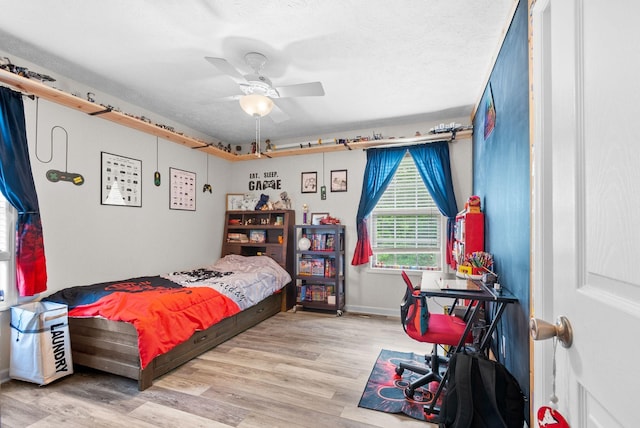 204 Commanche Dr, Hohenwald, TN 38462 - bedroom featuring a ceiling fan, baseboards, wood finished floors, and a textured ceiling