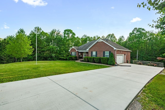 204 Commanche Dr, Hohenwald, TN 38462 - view of front of house featuring brick siding, a garage, driveway, and a front yard