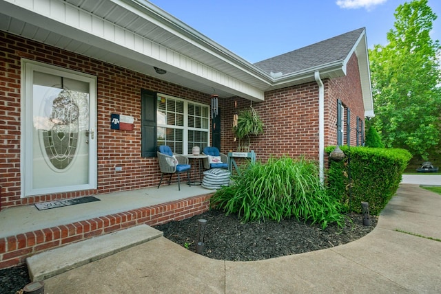 204 Commanche Dr, Hohenwald, TN 38462 - entrance to property with a porch, brick siding, and a shingled roof