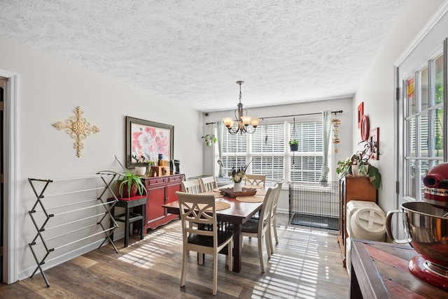 204 Commanche Dr, Hohenwald, TN 38462 - dining area with a textured ceiling, wood finished floors, and a notable chandelier