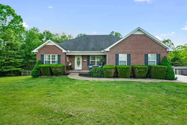 204 Commanche Dr, Hohenwald, TN 38462 - ranch-style home with a shingled roof, a front lawn, and brick siding