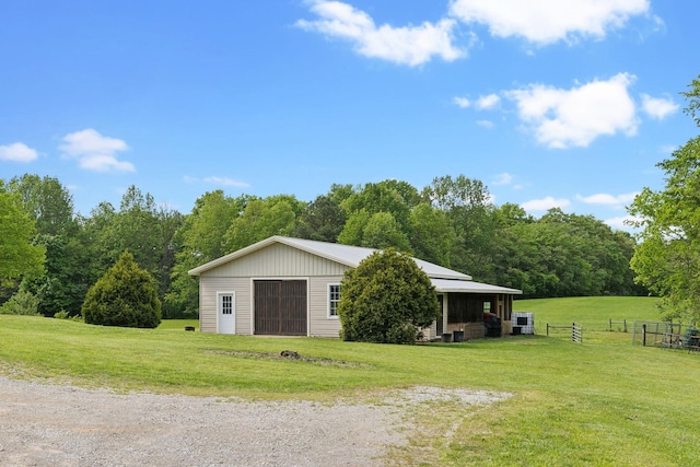 view of outbuilding featuring fence and a view of trees