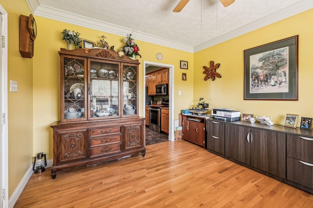 interior space with ceiling fan, stainless steel appliances, dark countertops, and light wood-style flooring