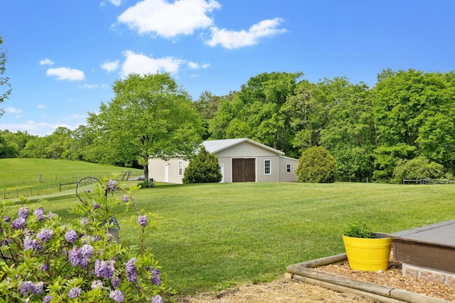 view of yard with fence and an outdoor structure