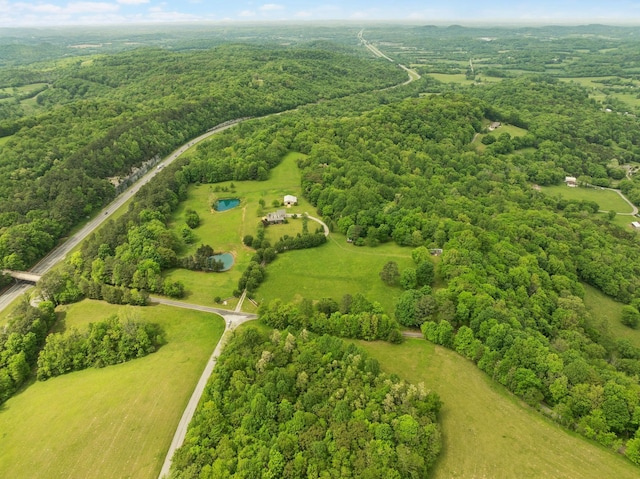 bird's eye view featuring a wooded view