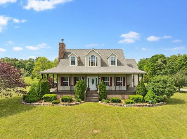view of front of property with a front lawn, roof with shingles, covered porch, and a chimney