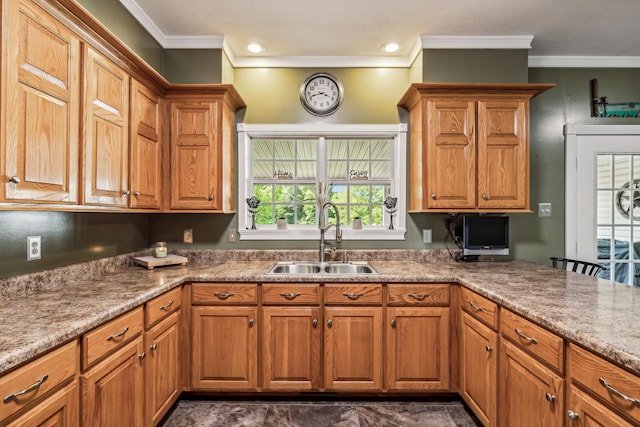 kitchen featuring brown cabinets, ornamental molding, and a sink