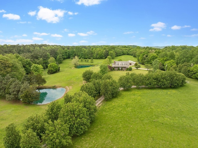 birds eye view of property featuring a water view and a forest view