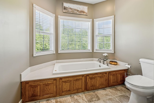 bathroom featuring toilet and a bath