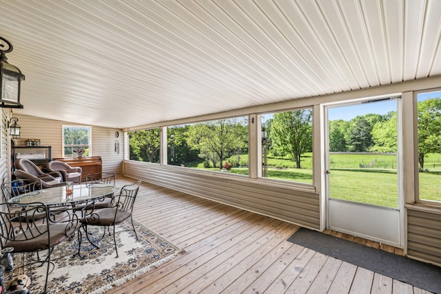 sunroom with outdoor dining space and plenty of natural light