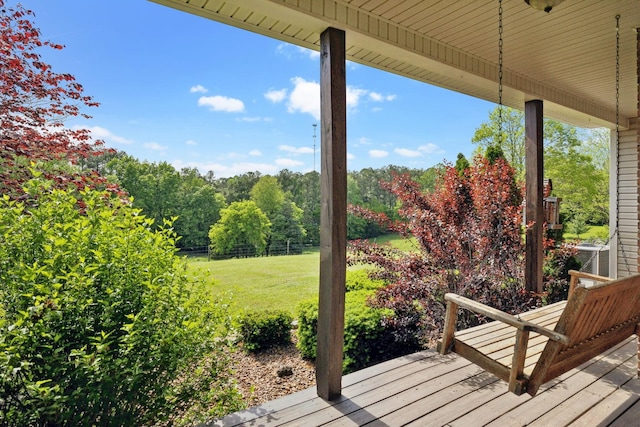 wooden terrace featuring a yard, central AC, and fence