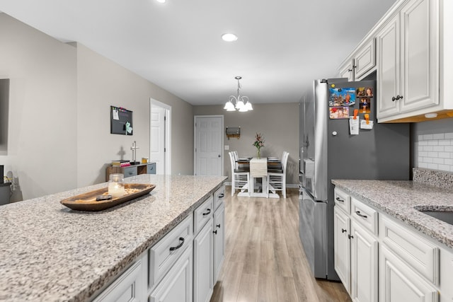 1356 Sayles Cir, Lawrenceburg, TN 38464 - kitchen featuring recessed lighting, a chandelier, light wood-type flooring, white cabinets, and freestanding refrigerator