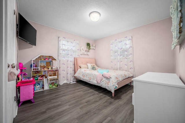 bedroom with wood finished floors and a textured ceiling